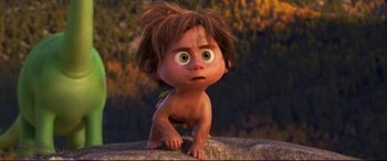 Movie still from “The Good Dinosaur” (2015), directed by Peter Sohn – A little boy that is sitting on the ground; Medium shot, High angle
