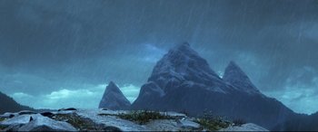 Movie still from “The Good Dinosaur” (2015), directed by Peter Sohn – A mountain range with a sky filled with rain; Extreme Wide shot, Low angle