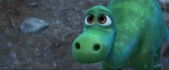 Movie still from “The Good Dinosaur” (2015), directed by Peter Sohn – The head and face of a green dinosaur; Close Up shot, High angle