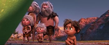 Movie still from “The Good Dinosaur” (2015), directed by Peter Sohn – A group of people standing next to each other on a field; Wide shot, Low angle