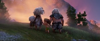 Movie still from “The Good Dinosaur” (2015), directed by Peter Sohn – A group of people in the grass holding hands; Wide shot, High angle