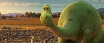 Movie still from “The Good Dinosaur” (2015), directed by Peter Sohn – The head and neck of a green dinosaur; Close Up shot, High angle