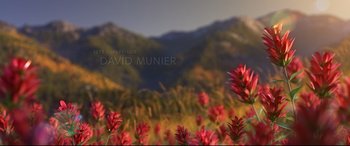 Movie still from “The Good Dinosaur” (2015), directed by Peter Sohn – A field of flowers with mountains in the background; Extreme Wide shot, High angle