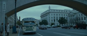 Movie still from “The Good Shepherd” (2006), directed by Robert De Niro – Cars driving down a street under a bridge; Extreme Wide shot, Low angle