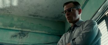 Movie still from “The Good Shepherd” (2006), directed by Robert De Niro – A man wearing glasses and a shirt and tie; Close Up shot, Low angle