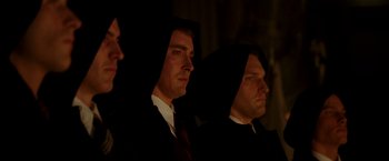Movie still from “The Good Shepherd” (2006), directed by Robert De Niro – A group of men standing next to each other wearing black robes; Medium shot, Low angle