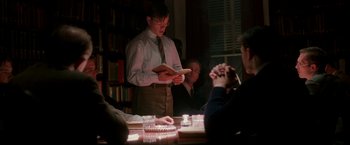 Movie still from “The Good Shepherd” (2006), directed by Robert De Niro – A group of people sitting around a table; Medium shot, Over the shoulder angle