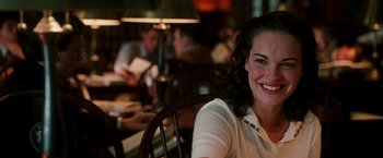 Movie still from “The Good Shepherd” (2006), directed by Robert De Niro – A woman sitting at a table in front of a group of people; Close Up shot, Over the shoulder angle