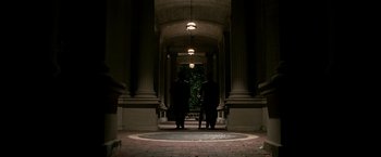 Movie still from “The Good Shepherd” (2006), directed by Robert De Niro – Two men are standing in an archway of a building; Extreme Wide shot, Low angle