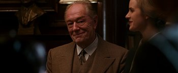 Movie still from “The Good Shepherd” (2006), directed by Robert De Niro – An older man wearing a suit and tie; Close Up shot, Over the shoulder angle