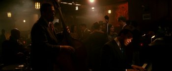 Movie still from “The Good Shepherd” (2006), directed by Robert De Niro – A group of people sitting in a room with microphones; Wide shot, Over the shoulder angle
