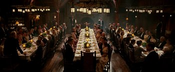 Movie still from “The Good Shepherd” (2006), directed by Robert De Niro – A group of people sitting around a long table; Wide shot, High angle