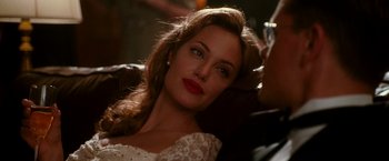 Movie still from “The Good Shepherd” (2006), directed by Robert De Niro – A woman with red lipstick is posing for a picture; Close Up shot, Over the shoulder angle