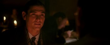 Movie still from “The Good Shepherd” (2006), directed by Robert De Niro – A person wearing a suit and tie; Close Up shot, Over the shoulder angle