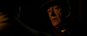 Movie still from “The Good Shepherd” (2006), directed by Robert De Niro – An older man wearing a hat looking at the camera; Close Up shot, Over the shoulder angle