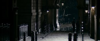 Movie still from “The Good Shepherd” (2006), directed by Robert De Niro – A person sitting on a bench in the dark; Extreme Wide shot, High angle