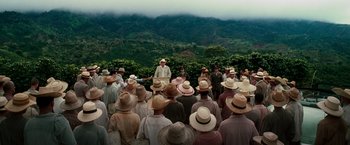 Movie still from “The Good Shepherd” (2006), directed by Robert De Niro – A large group of people wearing hats in a mountainous area; Extreme Wide shot, High angle