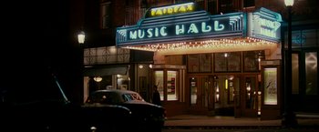Movie still from “The Good Shepherd” (2006), directed by Robert De Niro – A car parked in front of a music hall; Extreme Wide shot, Low angle