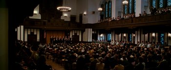 Movie still from “The Good Shepherd” (2006), directed by Robert De Niro – A group of people sitting in front of an audience in a church; Extreme Wide shot, High angle