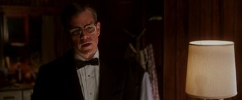 Movie still from “The Good Shepherd” (2006), directed by Robert De Niro – A man in a suit and bow - tie standing next to a door; Close Up shot, Low angle
