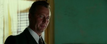Movie still from “The Good Shepherd” (2006), directed by Robert De Niro – A person wearing a suit and tie; Close Up shot, Low angle