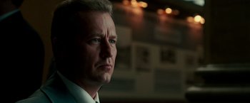 Movie still from “The Good Shepherd” (2006), directed by Robert De Niro – A person wearing a suit and tie; Close Up shot, Low angle