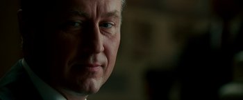 Movie still from “The Good Shepherd” (2006), directed by Robert De Niro – A man's face in a dark room; Close Up shot, Over the shoulder angle