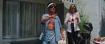 Movie still from “The Graduate” (1967), directed by Mike Nichols – A man and a woman standing next to each other; Medium shot, Low angle