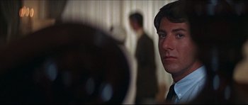 Movie still from “The Graduate” (1967), directed by Mike Nichols – A person in a suit and tie; Close Up shot, Over the shoulder angle