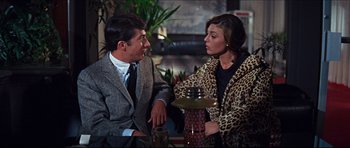 Movie still from “The Graduate” (1967), directed by Mike Nichols – A man and a woman sitting at a table talking to each other; Medium shot, Over the shoulder angle