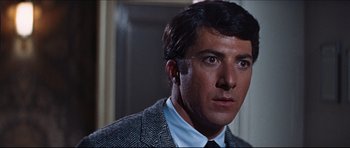 Movie still from “The Graduate” (1967), directed by Mike Nichols – A person wearing a suit and tie; Close Up shot, Low angle