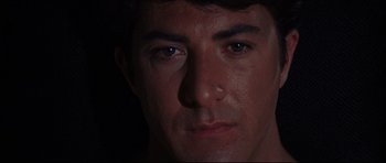 Movie still from “The Graduate” (1967), directed by Mike Nichols – A man's face in the dark; Close Up shot, Low angle