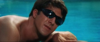 Movie still from “The Graduate” (1967), directed by Mike Nichols – A person wearing sunglasses in a swimming pool; Close Up shot, Low angle