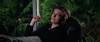 Movie still from “The Graduate” (1967), directed by Mike Nichols – A woman sitting in a chair holding a cell phone to her ear; Medium shot, Low angle