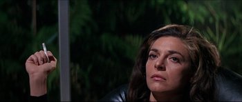 Movie still from “The Graduate” (1967), directed by Mike Nichols – A person sitting in front of a tree; Close Up shot, Low angle