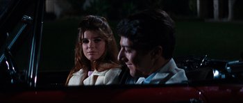 Movie still from “The Graduate” (1967), directed by Mike Nichols – A man and a woman sitting in the back of a car; Close Up shot, Over the shoulder angle