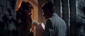 Movie still from “The Graduate” (1967), directed by Mike Nichols – A man and a woman are shaking hands in a room; Medium shot, Over the shoulder angle