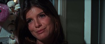 Movie still from “The Graduate” (1967), directed by Mike Nichols – A woman smiling for the camera; Close Up shot, Over the shoulder angle