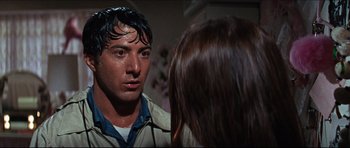 Movie still from “The Graduate” (1967), directed by Mike Nichols – A young man and a young woman in front of a bathroom mirror; Close Up shot, Over the shoulder angle