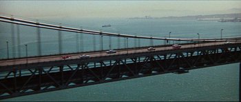 Movie still from “The Graduate” (1967), directed by Mike Nichols – A view of a bridge that is going over the water; Extreme Wide shot, High angle