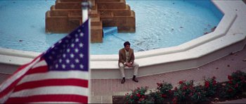Movie still from “The Graduate” (1967), directed by Mike Nichols – A man sitting on the edge of a swimming pool; Wide shot, High angle