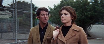 Movie still from “The Graduate” (1967), directed by Mike Nichols – A man and a woman standing next to each other; Medium shot, Low angle