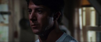 Movie still from “The Graduate” (1967), directed by Mike Nichols – A person wearing a white t - shirt; Close Up shot, Over the shoulder angle