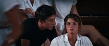 Movie still from “The Graduate” (1967), directed by Mike Nichols – A man and a woman sitting next to each other; Close Up shot, Over the shoulder angle
