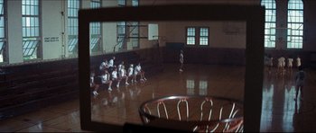 Movie still from “The Graduate” (1967), directed by Mike Nichols – A group of people sitting in a gym watching a basketball game; Extreme Wide shot, High angle