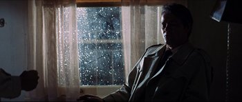 Movie still from “The Graduate” (1967), directed by Mike Nichols – A man sitting in front of a snowy window; Medium shot, Low angle