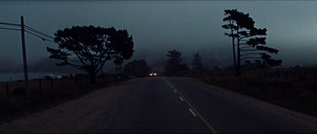 Movie still from “The Graduate” (1967), directed by Mike Nichols – The headlights of a car on the side of the road; Extreme Wide shot, High angle