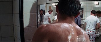 Movie still from “The Graduate” (1967), directed by Mike Nichols – Three men in a bathroom looking in a mirror; Medium shot, Over the shoulder angle