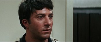 Movie still from “The Graduate” (1967), directed by Mike Nichols – A man's face in a white room; Close Up shot, Over the shoulder angle