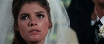 Movie still from “The Graduate” (1967), directed by Mike Nichols – The face of a woman wearing a wedding veil; Close Up shot, Over the shoulder angle